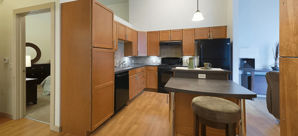 a kitchen with black appliances and wooden cabinets