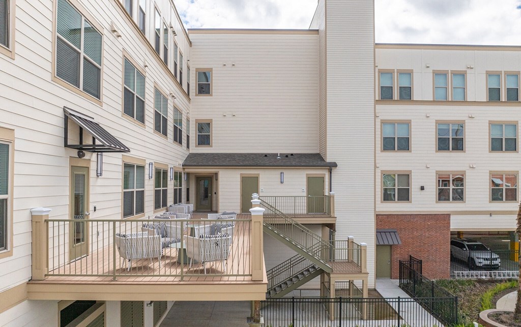 the outlook of an apartment building with a balcony and tables
