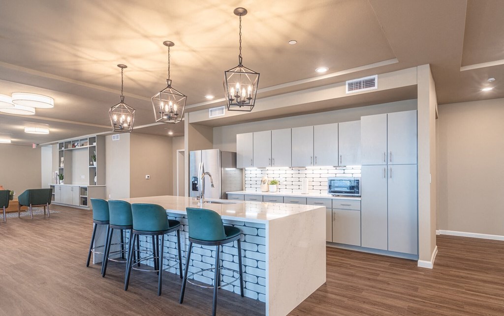 a kitchen with blue chairs and a white counter top