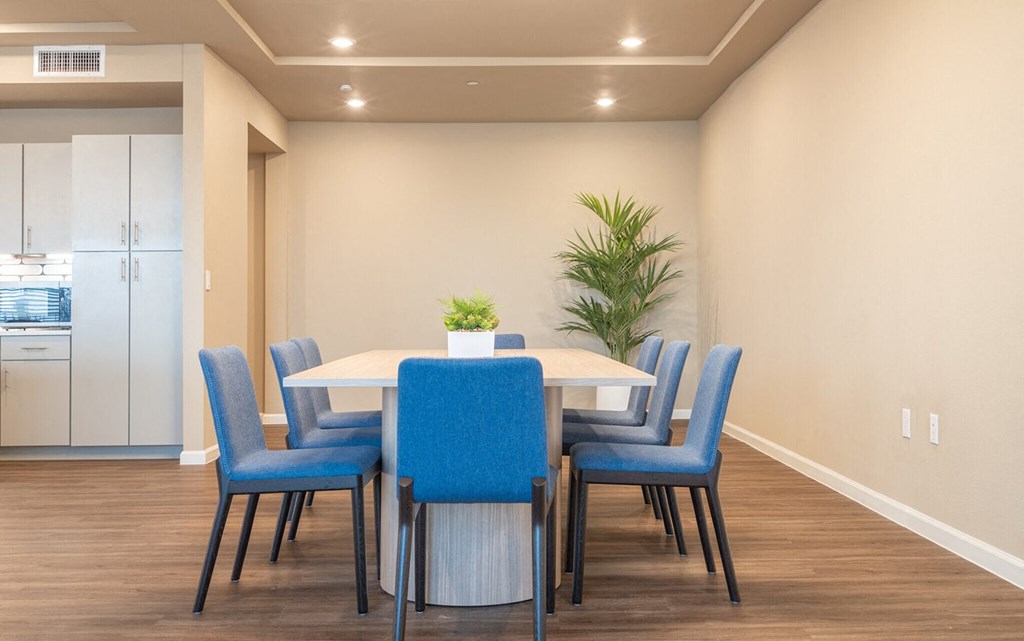 a dining room with blue chairs and a table