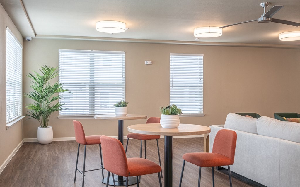 a living room with a table and chairs and a couch