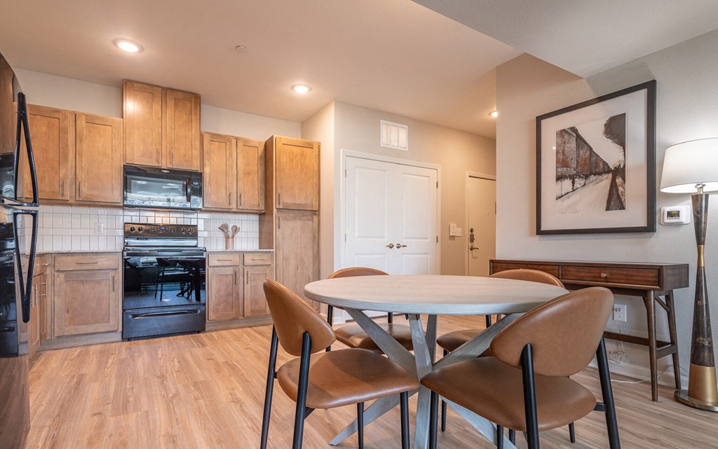 a kitchen and dining room with a table and chairs