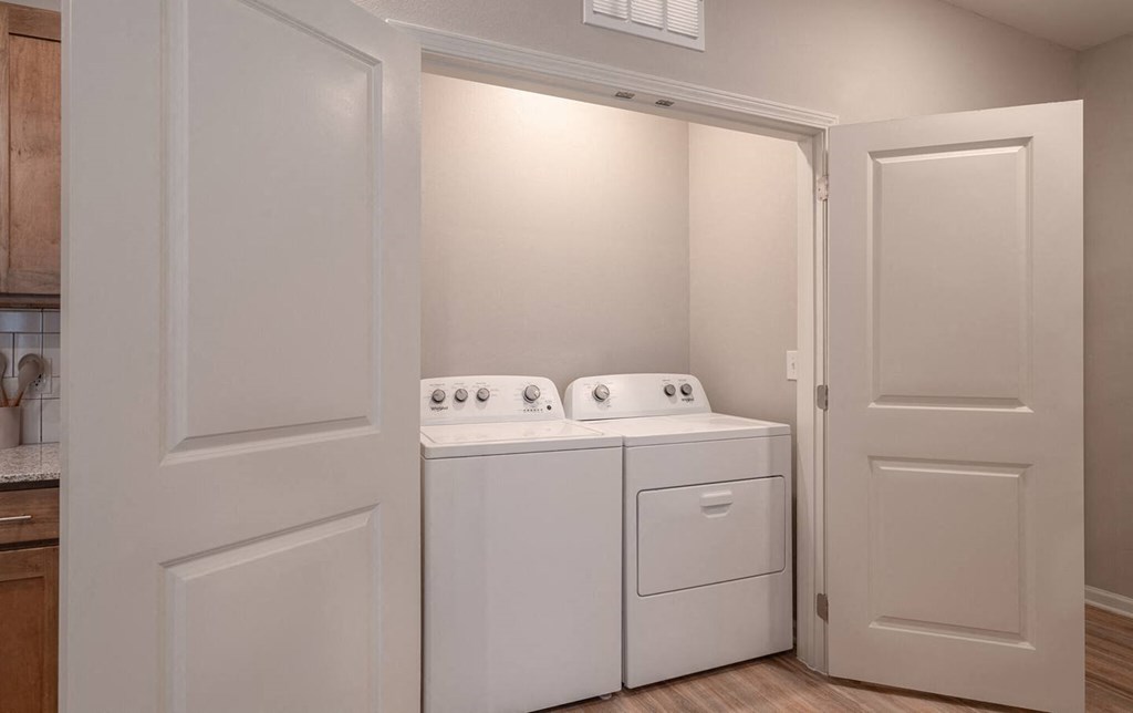 a washer and dryer in a laundry room with white doors