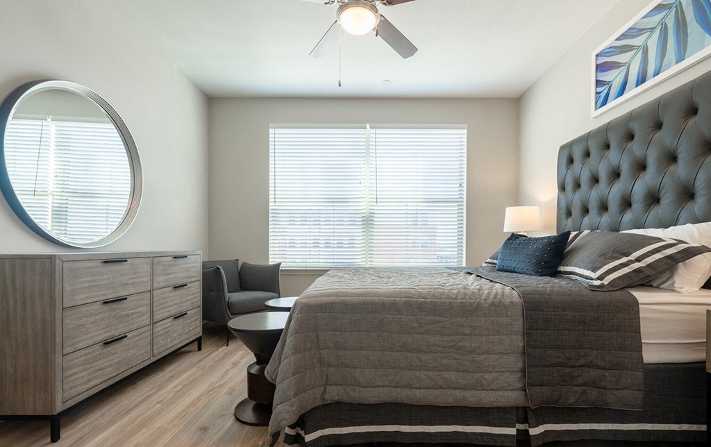a bedroom with a bed and a ceiling fan