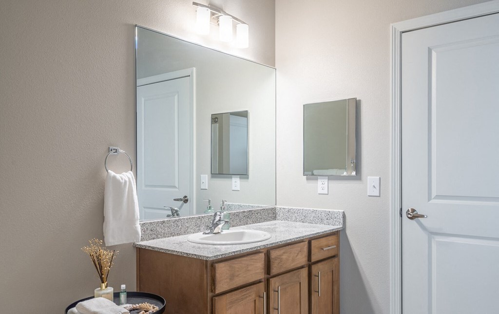 an empty bathroom with a sink and a mirror