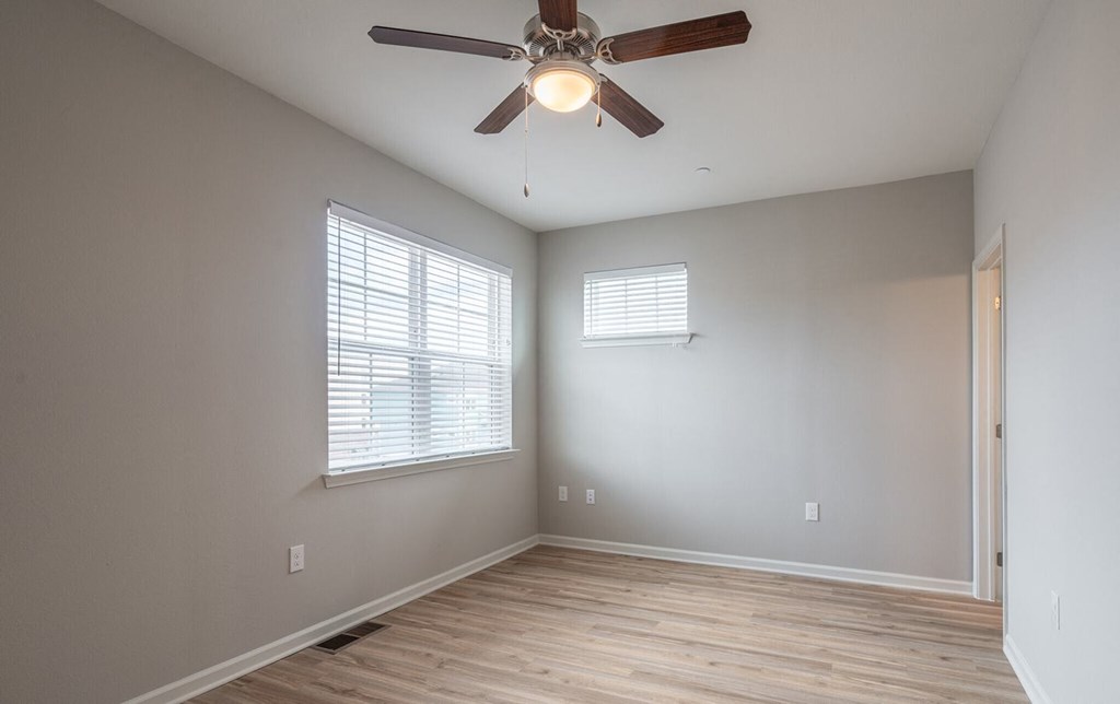 a living room with a ceiling fan and a window