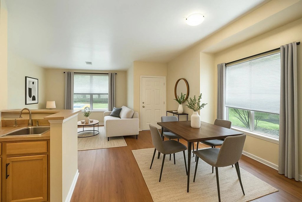 A modern kitchen with a dining table and chairs.