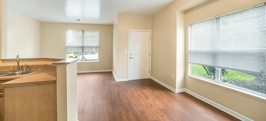 an empty kitchen and living room with a large window at Parsons Place Apartments