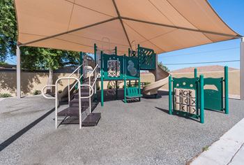 A playground with a slide, swings, and a climbing frame.