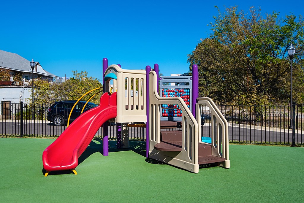 a playground with a slide and other playsets