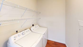 A white washing machine in a small laundry room.