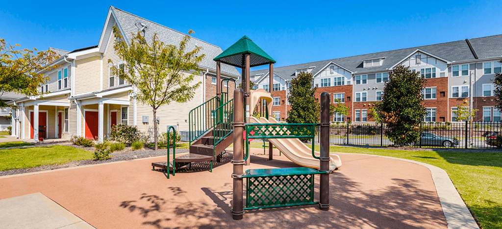 A playground with two beige slides at Quimby Plaza Apartments