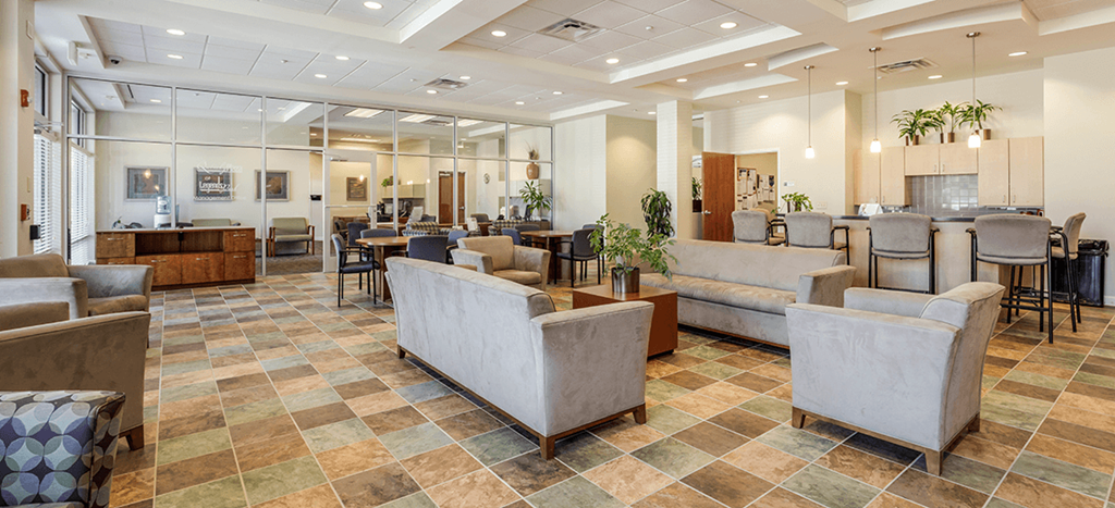 Clubhouse at Quimby Plaza Apartments with couches and chairs and tables in a building