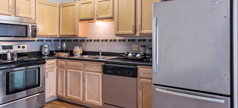 a kitchen with stainless steel appliances and wooden cabinets