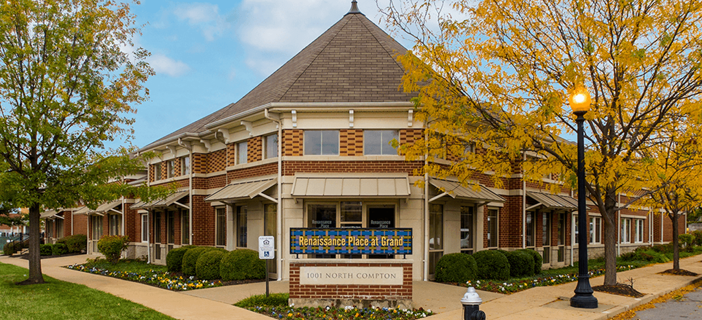 a building with a sign in front of it for Renaissance Place at Grand Apartments