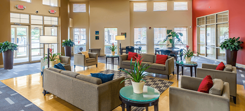 a living room with couches and chairs and a table