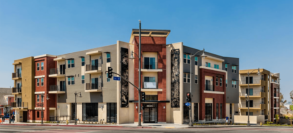 a row of apartment buildings on a city street at Santa Cecilia Apartments