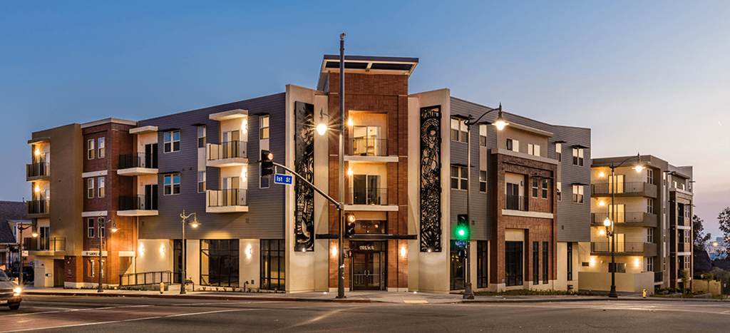 Santa Cecilia Apartment building on a city street with a traffic light