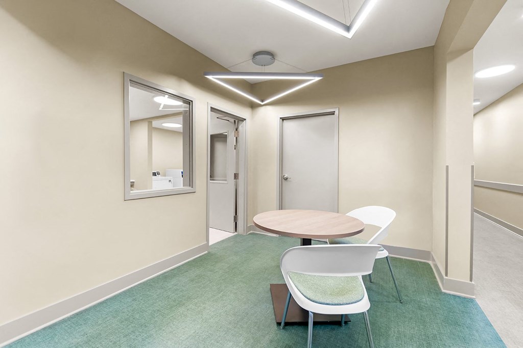 a meeting room with a table and chairs and a mirror at South City Senior in Memphis, TN