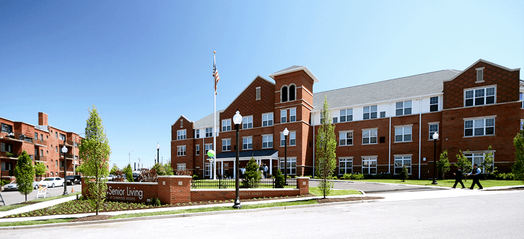 Cambridge Senior: a brick apartment building with an flag in front of it