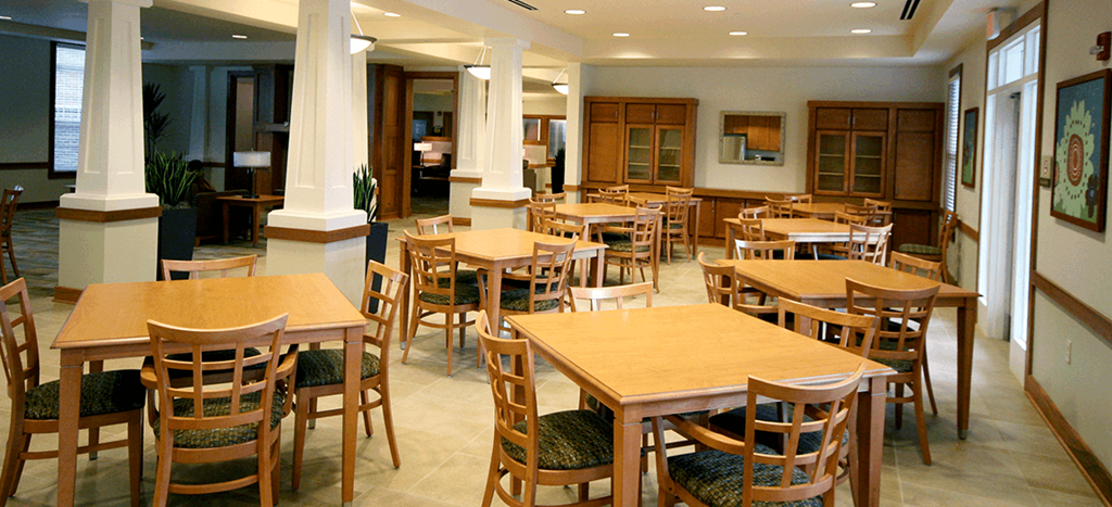 Cambridge Senior community room filled with wooden tables and chairs
