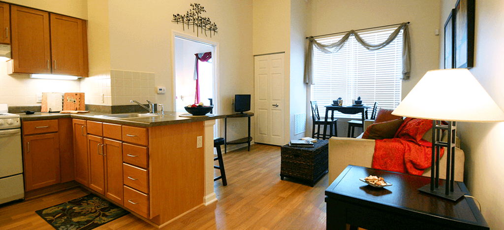 a living room at Cambridge Sr. with a kitchen and a dining room