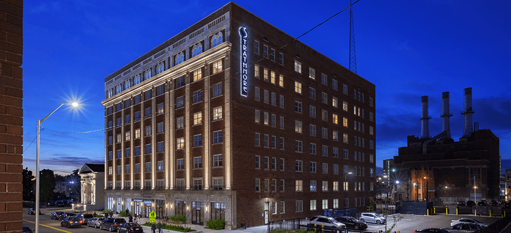 The Strathmore Apartments: a tall brick building at night