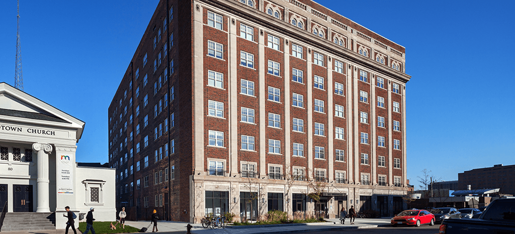 The Strathmore Apartments, a tall brick building on a city street