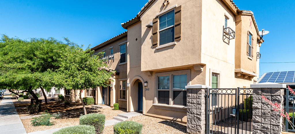 an apartment building with solar panels on the roof at The Symphony Apartments