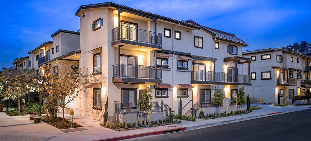 a row of apartments with balconies and street lights at Taylor Yard Apartments
