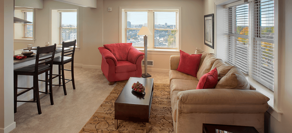 a living room with a couch and a table at Valentine Apartments
