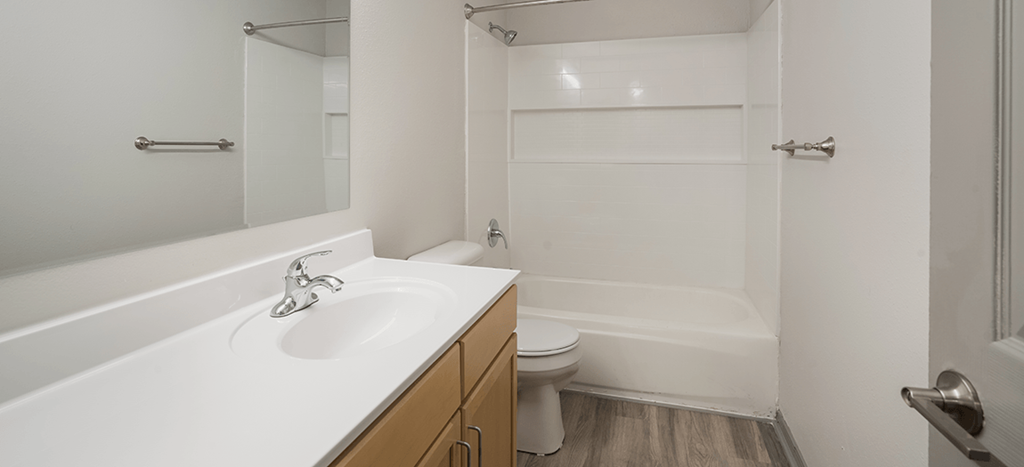 an empty bathroom with a sink and a toilet at Villa del Sol Apartments