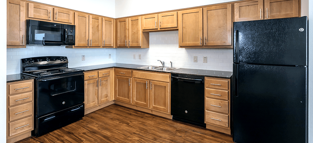 Villas on the Strand kitchen with black appliances and wooden cabinets