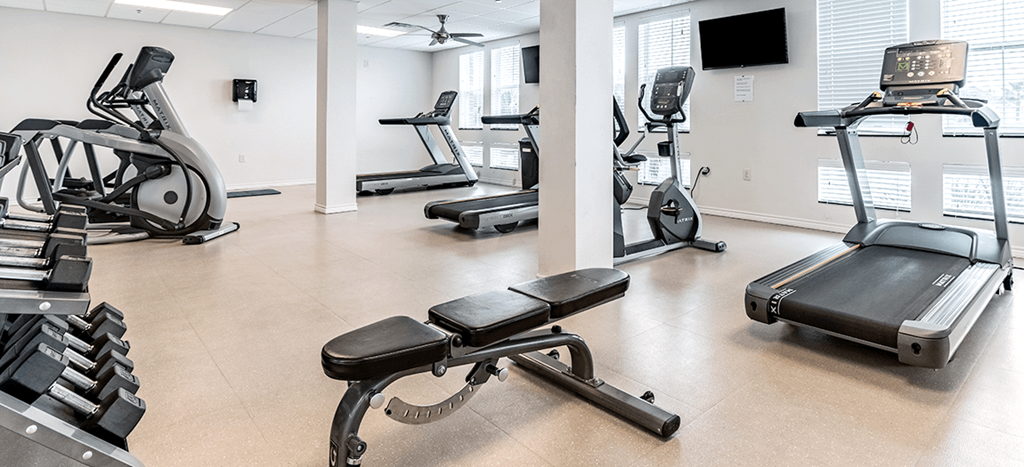 Fitness room at Villas on the Strand with treadmills and other exercise equipment