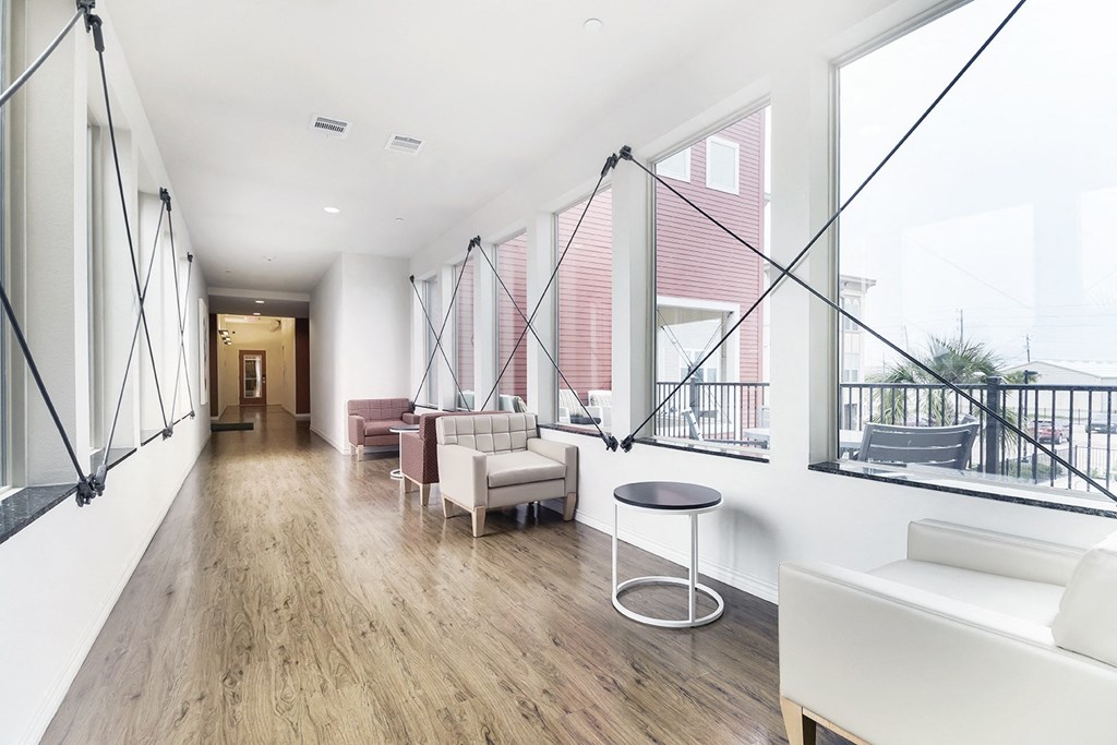 a living room with couches and chairs and a balcony