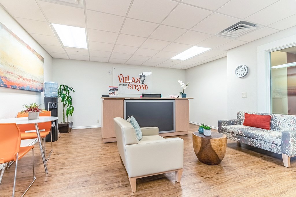 a living room with couches and chairs and a tv