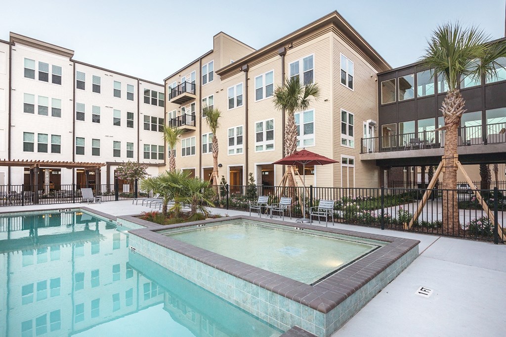 our apartments have a large swimming pool and a courtyard with palm trees