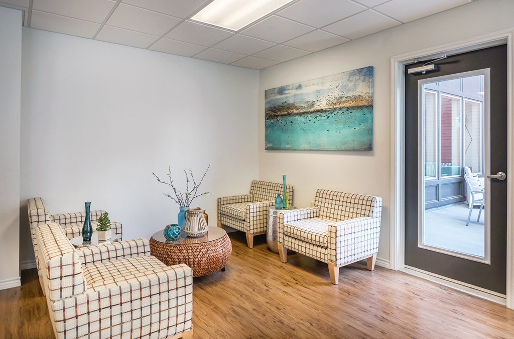 a living room with couches and a door to a balcony