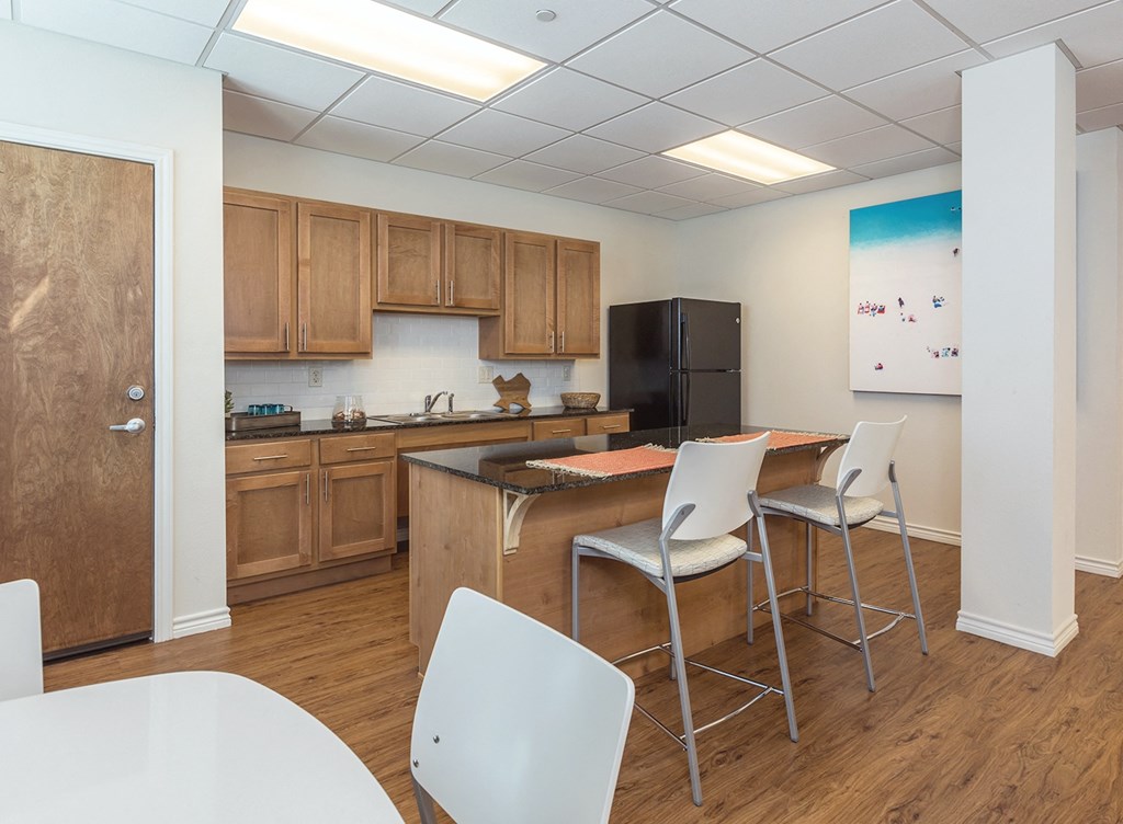 a kitchen with a table and chairs and a refrigerator