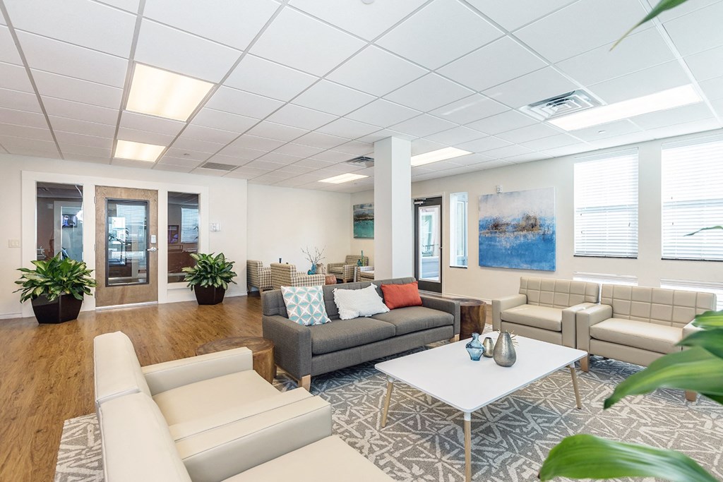 a living room with couches and chairs and a table