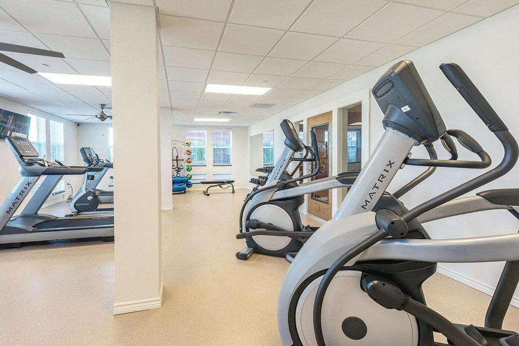 a gym with cardio machines and other exercise equipment