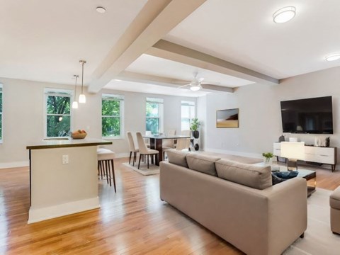 a living room and dining room with a couch and a table