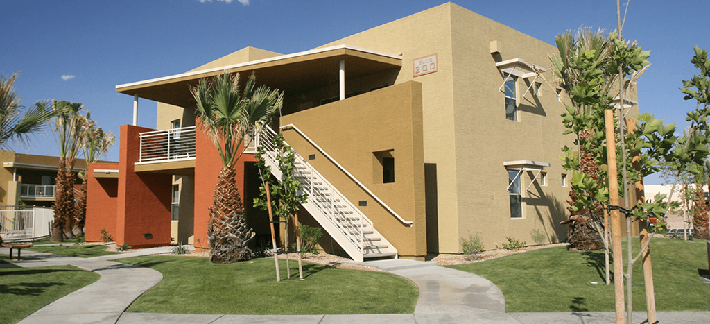 a building with a staircase and palm trees in front of it at Vista Sunrise Apartments