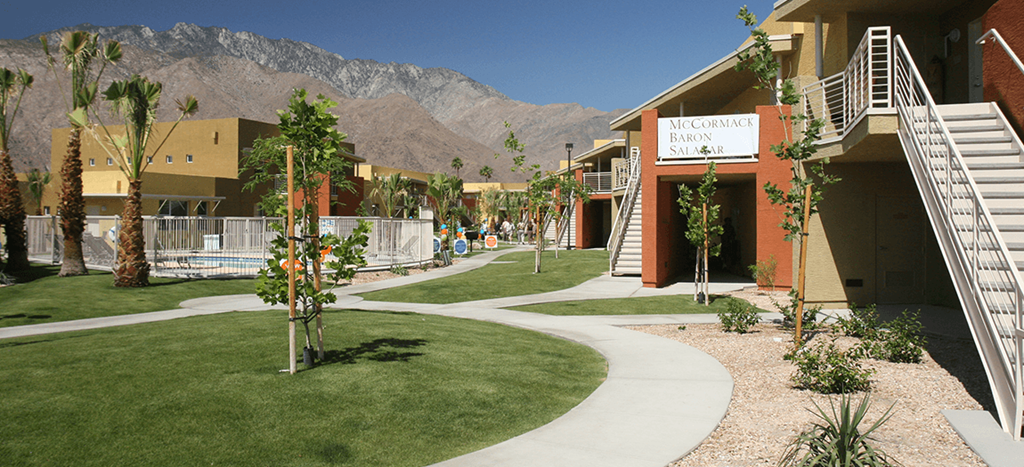 a view of a building with mountains in the background at Vista Sunrise Apartments