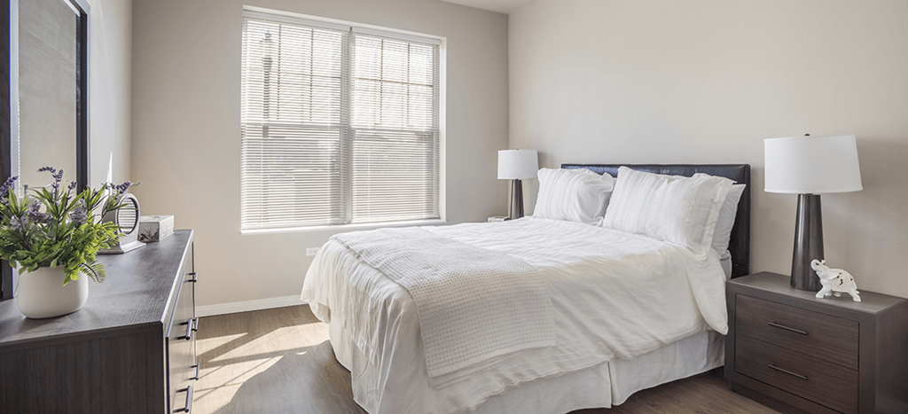a bedroom with a large bed and a window at West Park Apartments