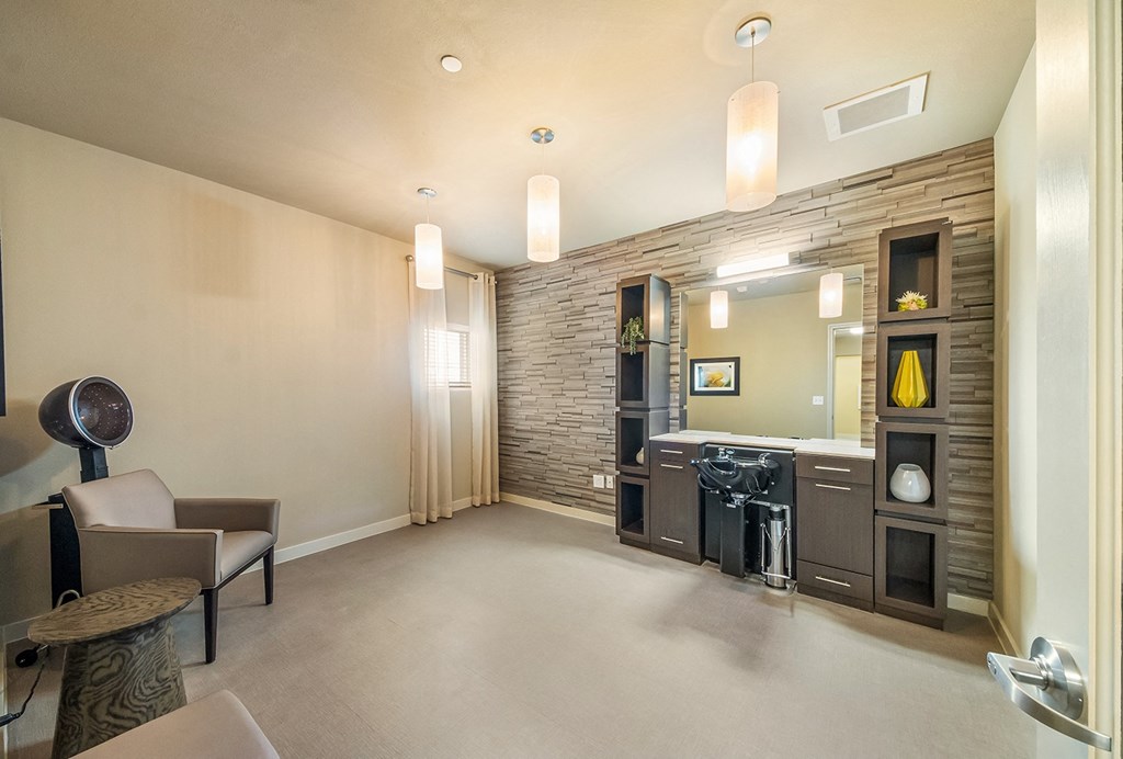 a living room with a fireplace and a kitchen