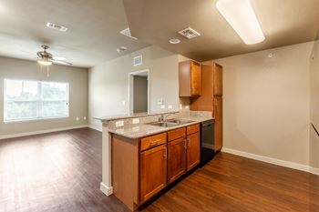an empty kitchen with a counter top and a sink at Wheatley Park Senior Living San Antonio