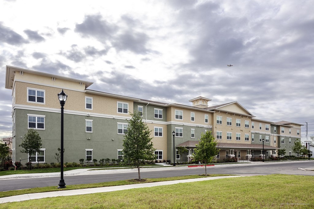 a large apartment building on the corner of a street