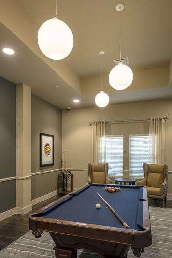 a rec room with a pool table and chairs at Wheatley Senior Living San Antonio