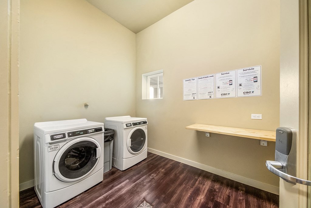a laundry room with two washes and a dryer